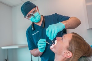 Doctor performing teeth cleaning